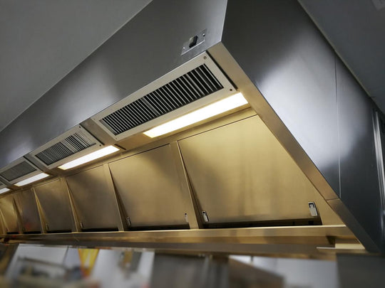 Ultraviolet UVC lights in a professional kitchen hood.